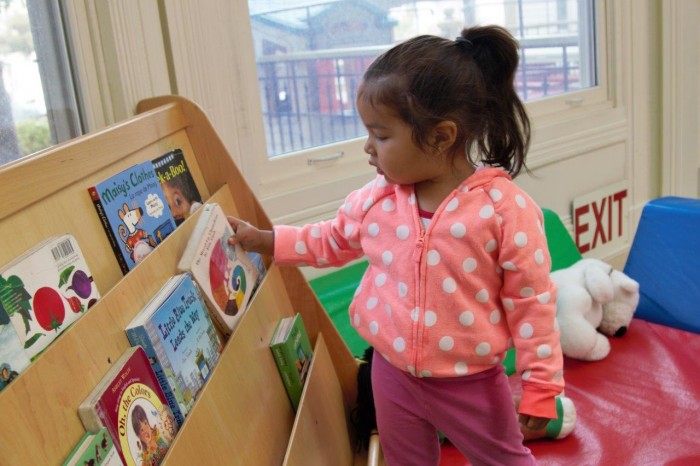 Preschooler choosing a book at Saint Vincent's Day Home
