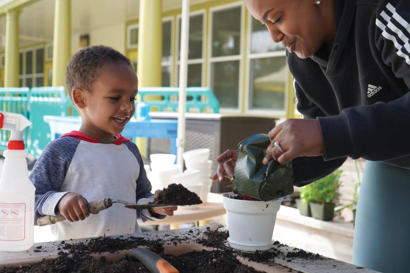 Preschool Teacher And Student Potting A Plant At Saint Vincent'S Day Home